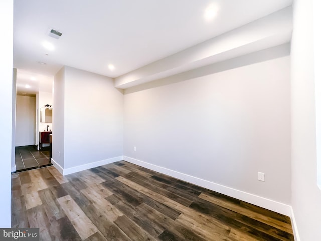 unfurnished room with dark wood-type flooring