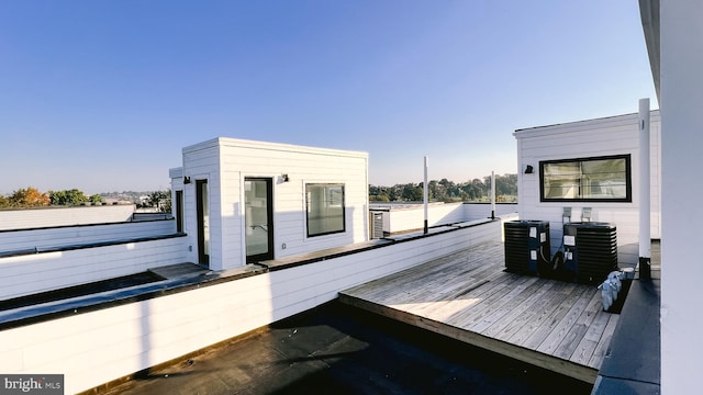 wooden deck featuring cooling unit