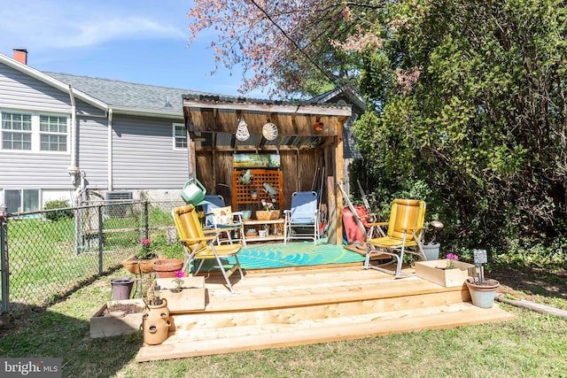 deck featuring fence and a lawn