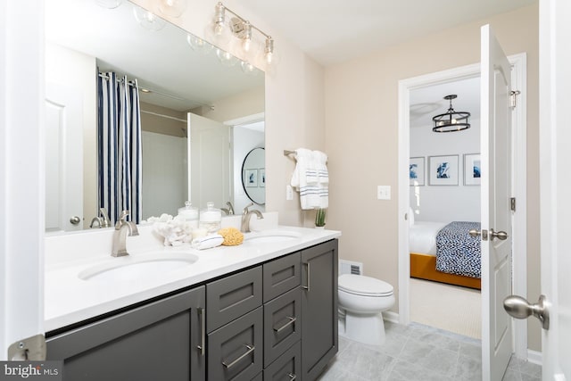 TBB Westmoreland Way Clemson Ii, Charles Town, WV 25414 - bathroom featuring double vanity, toilet, connected bathroom, and a shower with shower curtain