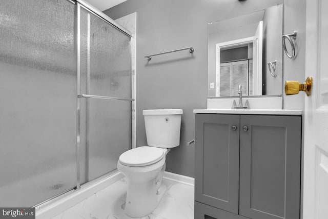 bathroom with a shower with door, vanity, and toilet