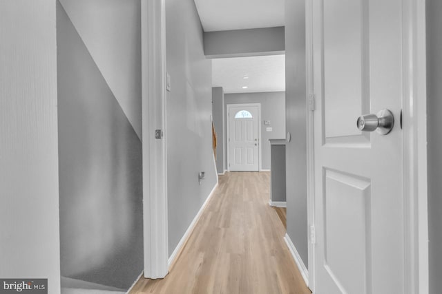 hallway with light hardwood / wood-style floors