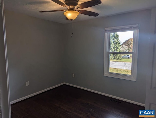 spare room with ceiling fan and dark hardwood / wood-style floors