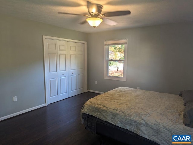 bedroom with dark hardwood / wood-style flooring, a closet, and ceiling fan