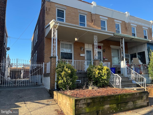 townhome / multi-family property with covered porch