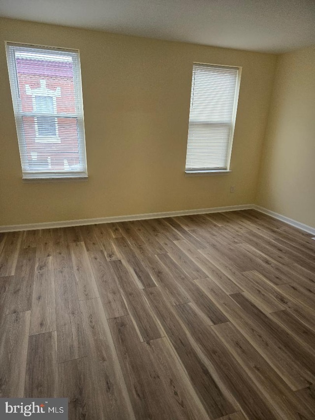 unfurnished room featuring hardwood / wood-style flooring