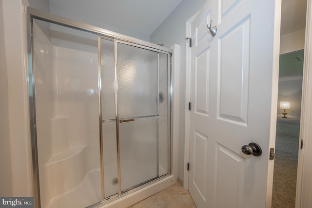 bathroom with tile patterned flooring and walk in shower