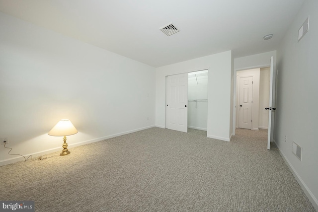 unfurnished bedroom with a closet and carpet