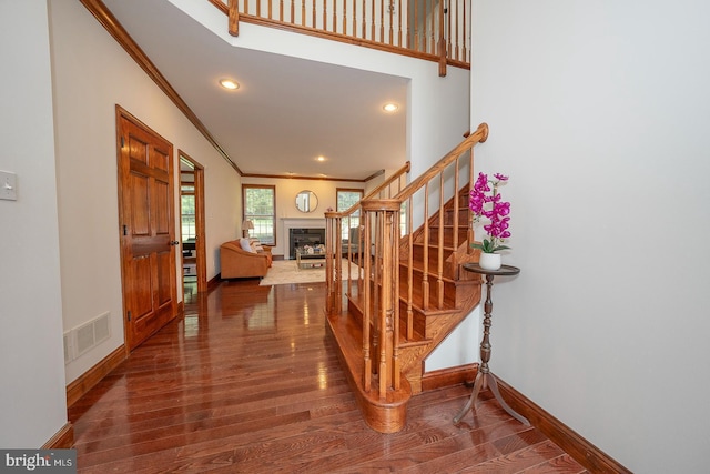 foyer entrance featuring dark hardwood / wood-style flooring and ornamental molding