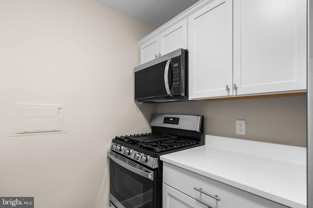 kitchen with white cabinets and gas range