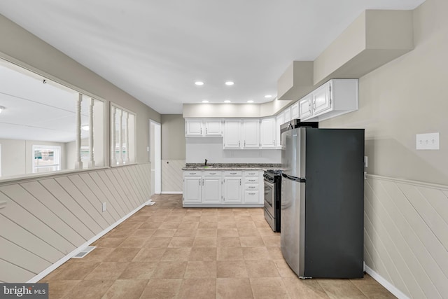 kitchen featuring white cabinets, appliances with stainless steel finishes, and sink