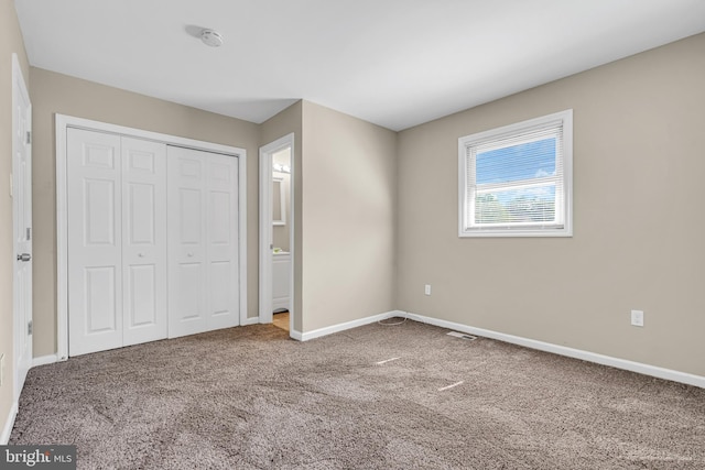 unfurnished bedroom with carpet and a closet