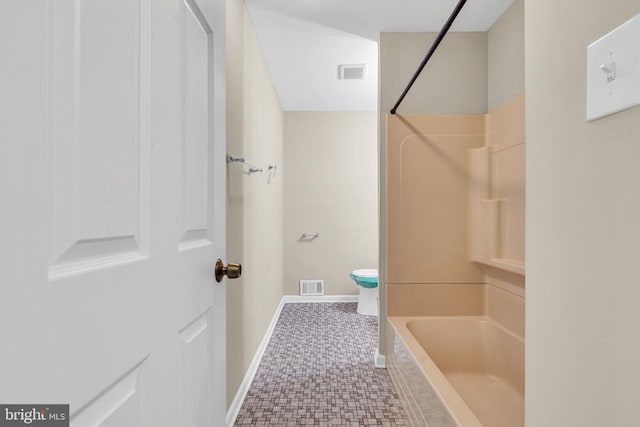 bathroom featuring tile patterned flooring, shower / tub combination, and toilet