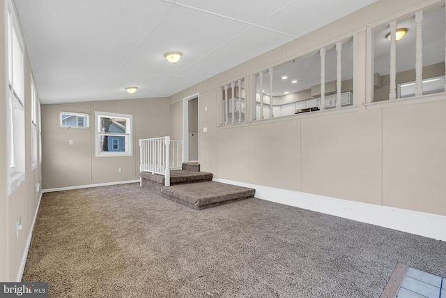 unfurnished living room with carpet and lofted ceiling