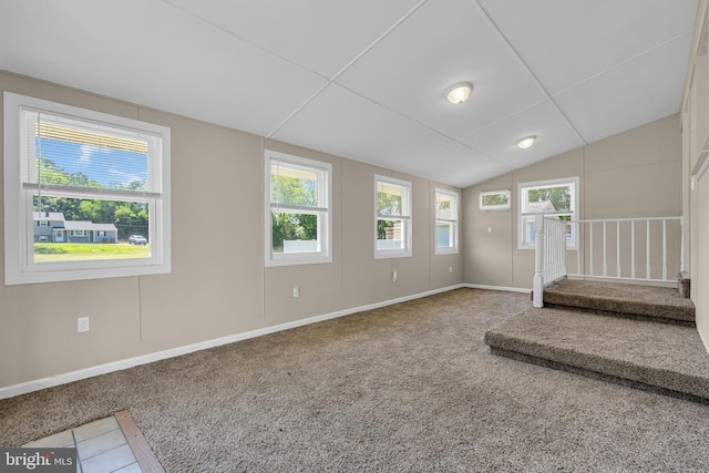 interior space featuring carpet flooring, vaulted ceiling, and plenty of natural light