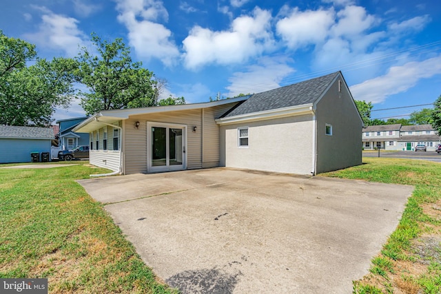 rear view of property with a patio area and a lawn