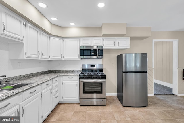 kitchen featuring white cabinets, stainless steel appliances, and sink