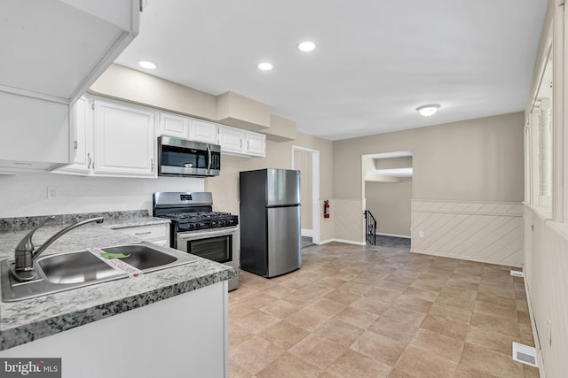 kitchen featuring white cabinetry, sink, and appliances with stainless steel finishes