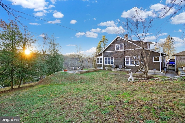 back of property featuring a yard and a patio