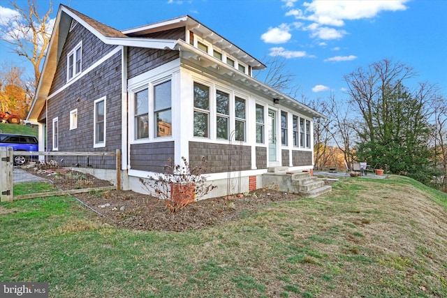 view of home's exterior with a lawn