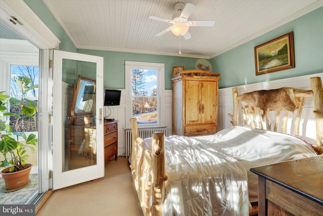 bedroom featuring access to exterior, ceiling fan, radiator heating unit, crown molding, and light colored carpet