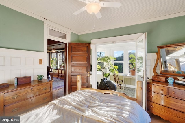 bedroom with ceiling fan, crown molding, and multiple windows