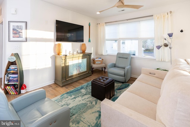 living room featuring wood-type flooring and ceiling fan