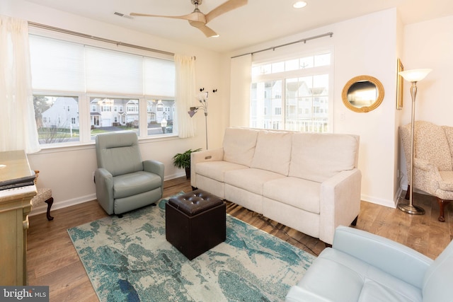 living room featuring hardwood / wood-style flooring and ceiling fan