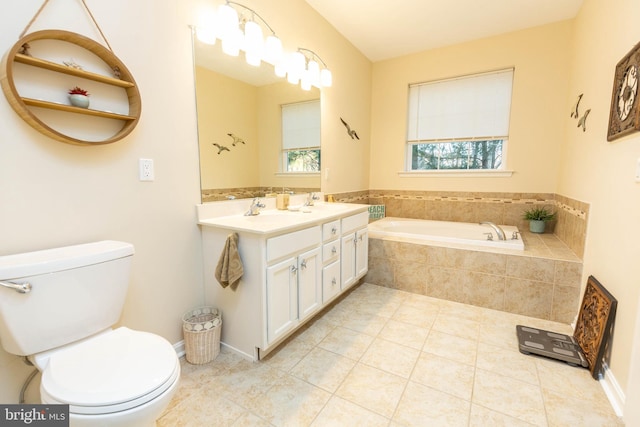 bathroom with vanity, tile patterned flooring, a relaxing tiled tub, and toilet