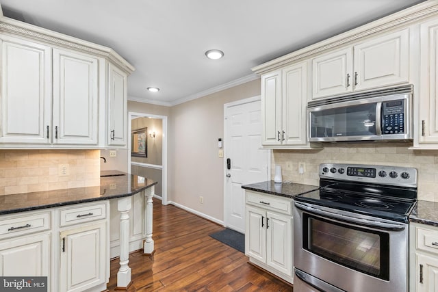 kitchen with backsplash, dark stone countertops, dark wood-type flooring, and stainless steel appliances