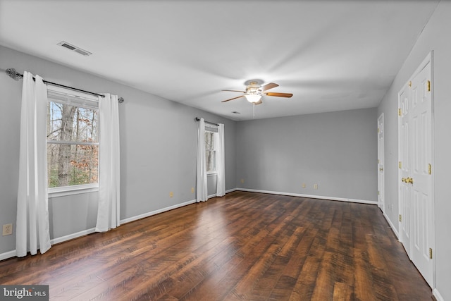 empty room featuring ceiling fan and dark hardwood / wood-style flooring