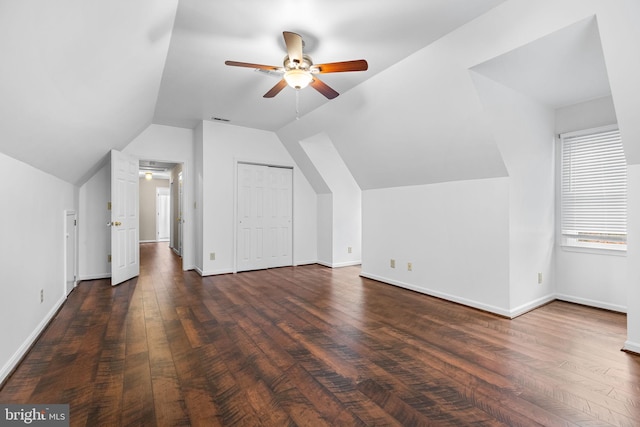 bonus room with ceiling fan, dark wood-type flooring, and vaulted ceiling