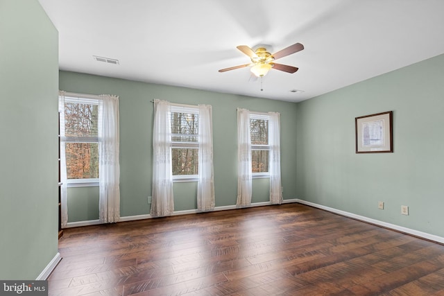 unfurnished room with ceiling fan and dark wood-type flooring