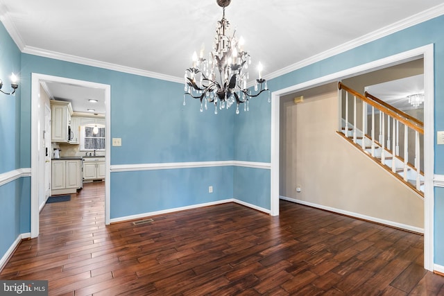 unfurnished dining area featuring ornamental molding, sink, dark wood-type flooring, and a notable chandelier