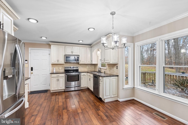 kitchen with sink, hanging light fixtures, stainless steel appliances, dark hardwood / wood-style flooring, and crown molding