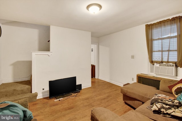 living room with cooling unit and light hardwood / wood-style floors