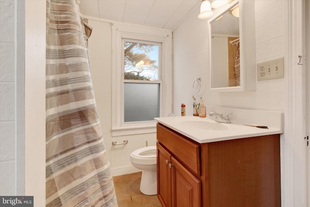 bathroom with tile patterned flooring, vanity, and toilet