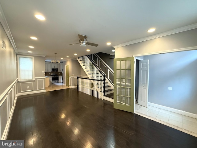 interior space featuring ceiling fan, crown molding, and dark wood-type flooring