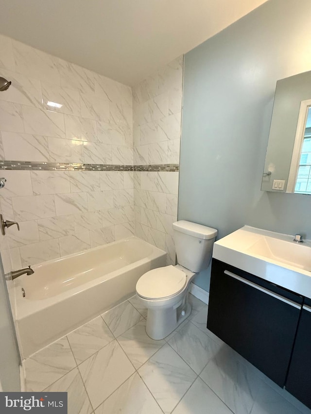 full bathroom featuring vanity, tiled shower / bath combo, and toilet