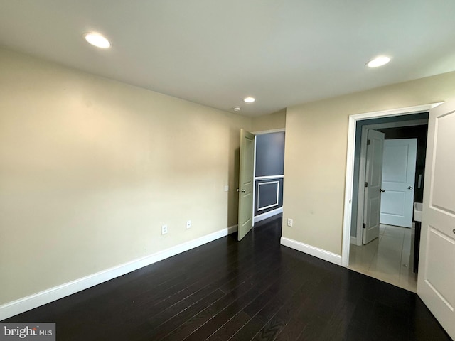 unfurnished bedroom featuring dark hardwood / wood-style floors