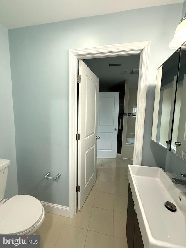 bathroom featuring tile patterned flooring, toilet, and sink