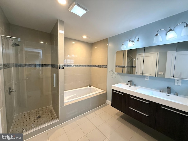 bathroom with tile patterned flooring, vanity, and shower with separate bathtub