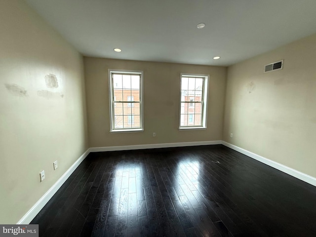 empty room featuring dark hardwood / wood-style flooring