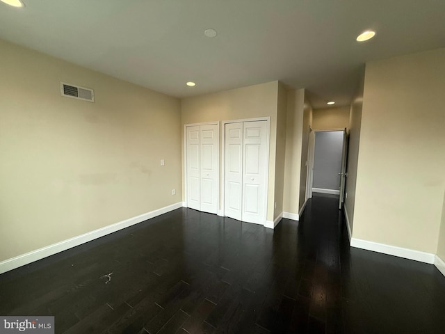 unfurnished bedroom featuring dark hardwood / wood-style floors