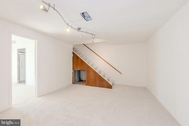 additional living space featuring light colored carpet