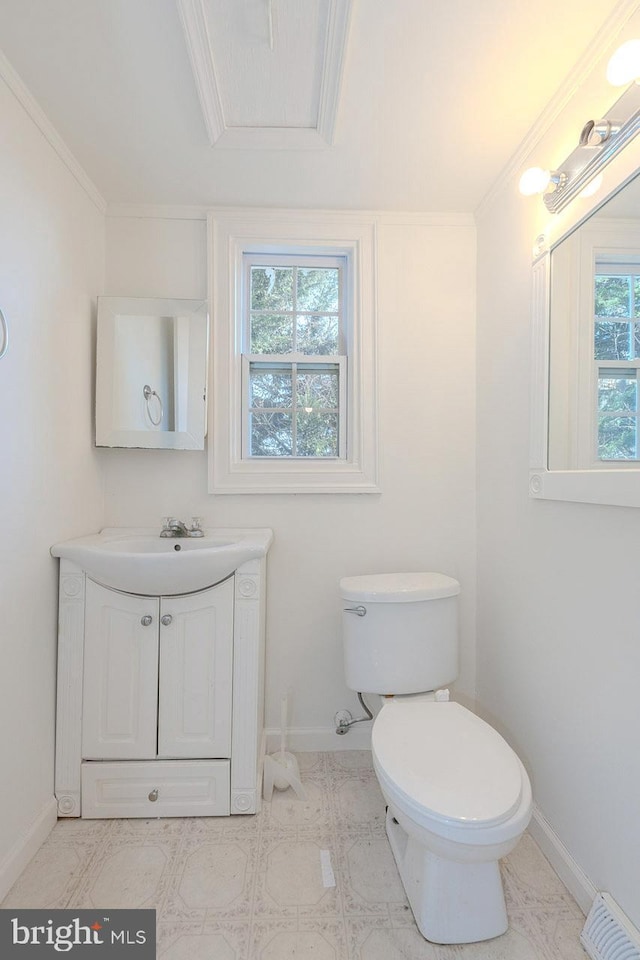 bathroom featuring vanity, toilet, crown molding, and a wealth of natural light