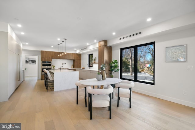 dining area featuring light hardwood / wood-style floors and sink