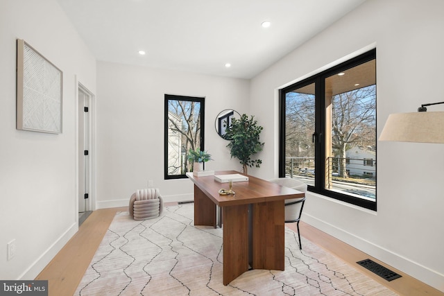 office with light wood-type flooring