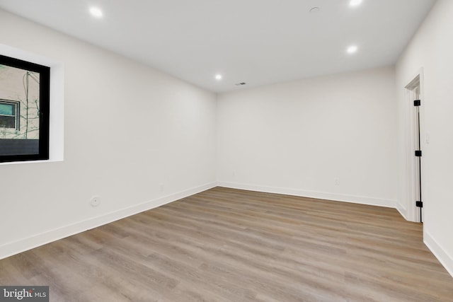 spare room with light wood-type flooring