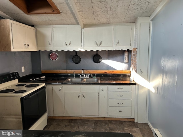 kitchen with electric range, white cabinets, baseboard heating, and sink